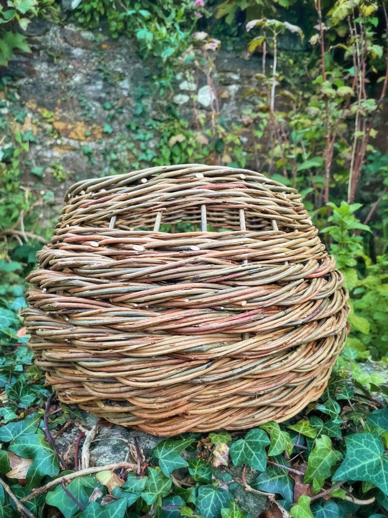 Curved rope weave basket with integrated handles